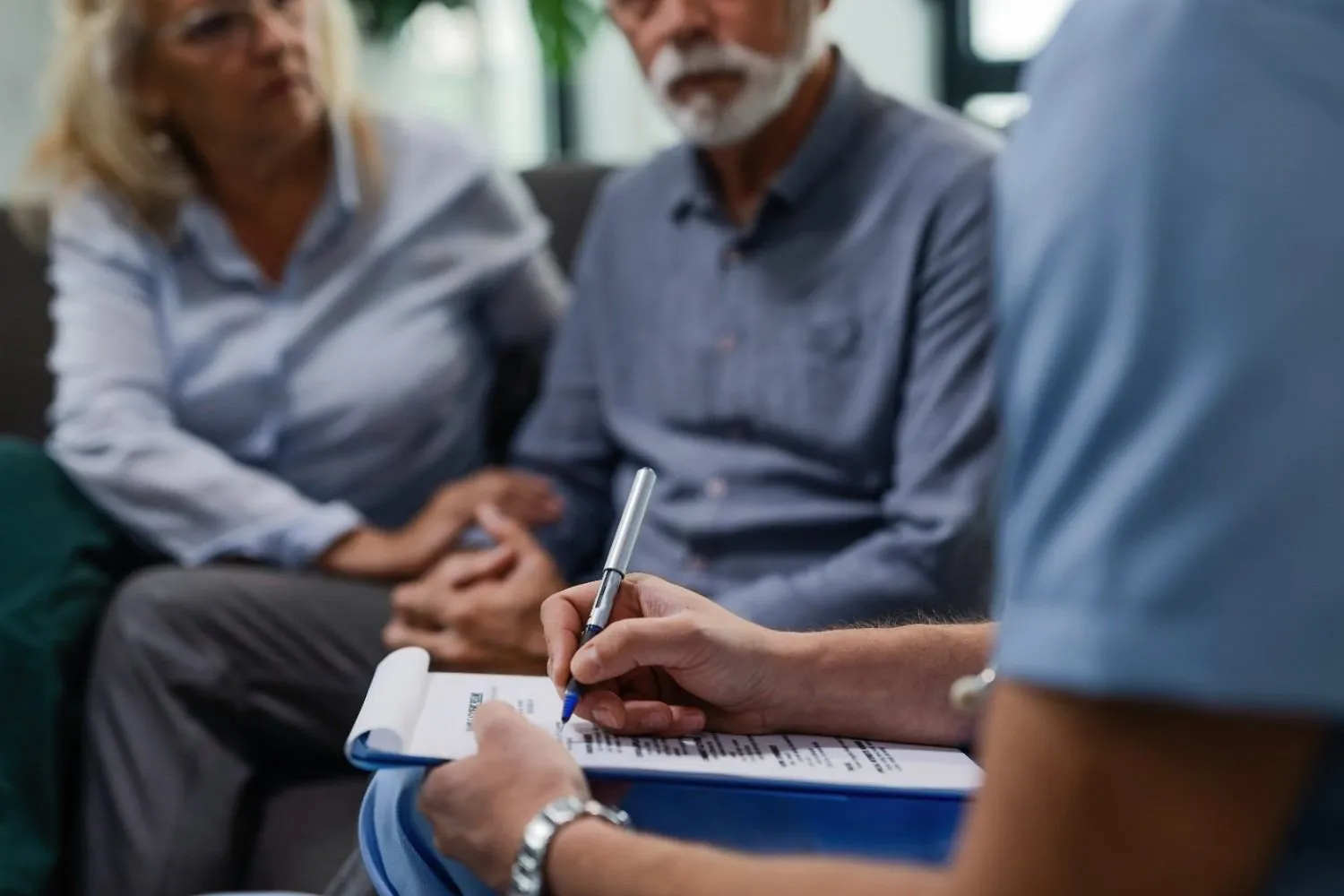 An adviser going through Medicare paperwork with an older couple